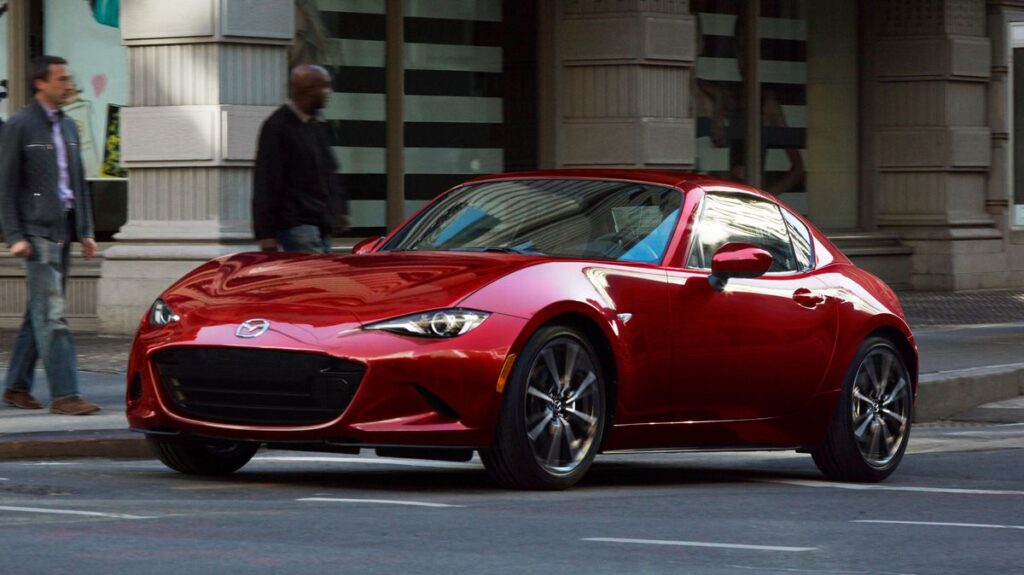 2024 mazda mx 5 miata red front in motion 65b3c9cfef394 1 Top Cars With Best Handling 2024: Ultimate Driving Experience